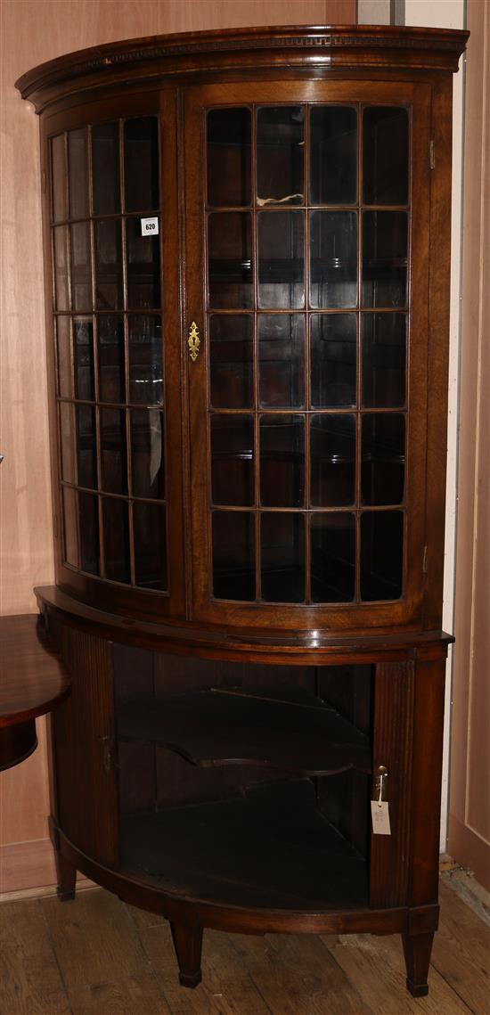 A Regency style mahogany bowfront corner cabinet, W.3ft 3in. H.6ft 4in.